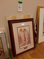 Full view of framed print leaning against wall