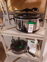 Hamilton Beach slow cooker on shelf with spoon