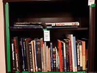 Two shelves of assorted hardcover books visible.