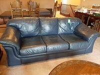 Front view showing full three-seat navy leather sofa