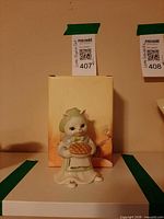 Front view of cat figurine with box