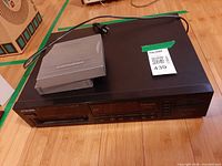 Top view of CD changer with magazine and power cord displayed