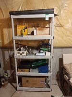 Full view of loaded plastic shelving unit with contents