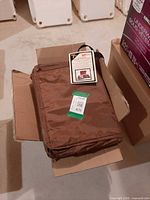 Brown nylon portfolio case folded in box