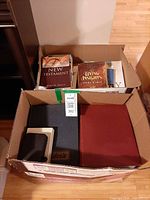 Both cardboard boxes with various religious books visible