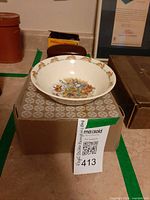 Bowl resting on a box with lot tag visible