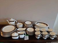 Group shot of entire dinnerware set on sideboard