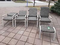 Front view of four reclining chairs and ottoman showing frames and cushions