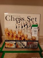 front of boxed shot glass chess set showing contents illustration