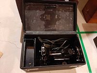 Singer Featherweight sewing machine inside case showing machine body and cord