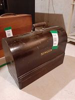 Front view of closed dark brown bentwood Singer case with handle