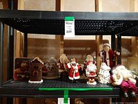 All ten Santa figurines displayed on shelf