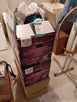Three stacked cardboard boxes holding fabric