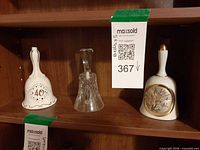 All three bells side by side on shelf