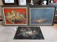 All three paintings together: two framed standing, one unframed on floor