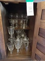 Cabinet interior showing full assortment of crystal stemware on shelves