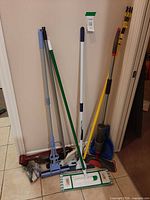 Full group of cleaning tools leaning against wall