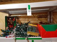 Boxed Holiday Creations musical Santa, heap of string lights, Stanley remote package on shelf