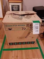 Original carton front with Precision Optical Instrument labeling