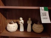 Full set on shelf: two figurines between two inscribed orbs