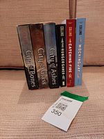 All six novels standing upright showing spines