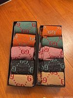 Open boxes showing rolled sparkly socks in assorted colours