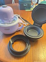Purple Dash My Pint ice cream maker, open aqua Dash mini pie maker, black cutter ring