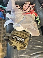 Shark costume, pink harness, bandana, tactical harness visible