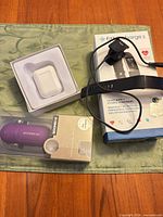 All items together: Fitbit Charge 2 box with tracker and cable, Boombox v2 box, wireless earbuds case