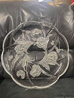 Front view of clear glass serving platter showing floral motif and sectioned design