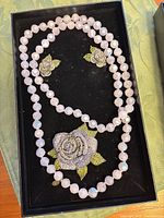 Set in box showing necklace, brooch/pendant, earrings