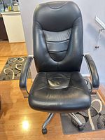 Front view showing seat, backrest, armrests, base and casters