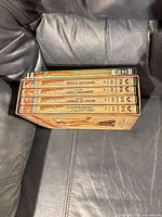 Spine view of four DVDs—Bonus Material, Last Crusade, Temple of Doom, Raiders of the Lost Ark—in outer slipcase