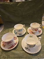 Four teacup and saucer sets displayed together