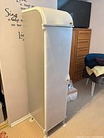 Full view of cabinet closed, showing curved top and feet