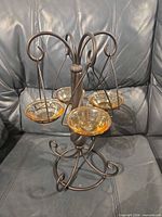 Full view of Partylite metal tea light holder with four amber glass cups