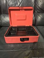 Cash box open showing interior tray and combination lock