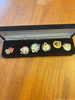 Six enamel Olympic pins in presentation box