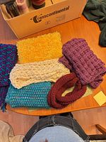 All six scarves spread on table