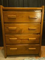 Front view of four-drawer solid wood dresser closed