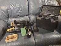 Overall view of sewing machine, case, pedal, accessories