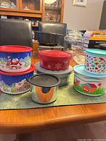 Group shot of all seven containers showing designs and lids