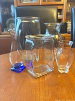 All five vases grouped on tabletop showing varied shapes and sizes