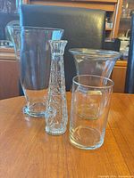 Front view showing all four clear glass vases together