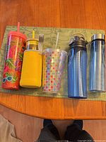 All five drink containers lined up on table runner