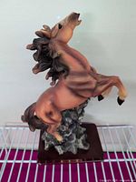 Front left view of resin horse figurine on base
