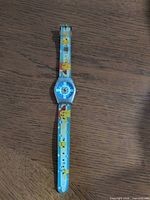 Front view showing full length of watch with Pikachu graphics on strap