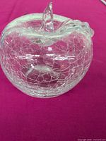 Front three-quarter view of clear crackle glass apple paperweight