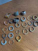 All rings laid out showing variety of styles and finishes