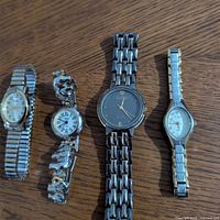 All four wristwatches laid out side by side